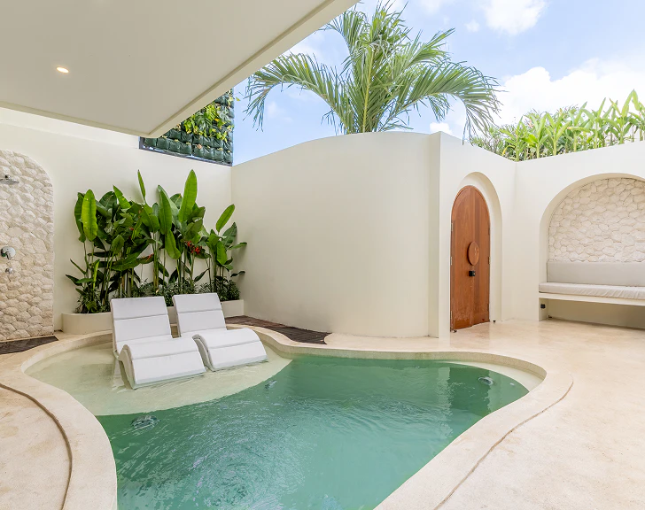 Villa plunge pool with white loungers
